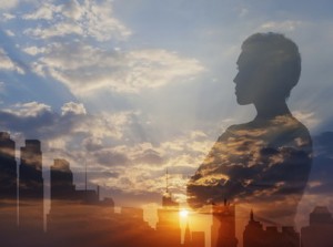 Silhouette of mixed race businesswoman and city skyline